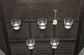 The fire screen with the candle holders.