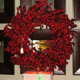 A lovely berry wreath in the center of 6 framed small mirrors.