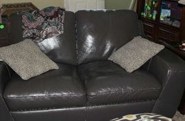 The gray leather love seat.