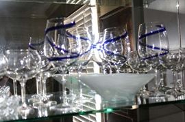 Some of the cocktail glasses with a ocean blue glass owl.