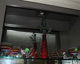 Beautiful red stripe cocktail glasses with red glass bottle.