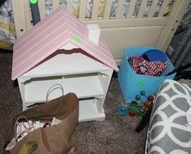 A wood doll house that is painted pink and white.  Has the furniture and people in the paper bag.  