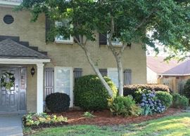 A view of the side of the front of house.