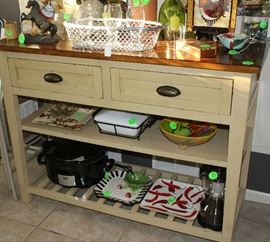 A beautiful mustard colored cabinet with drawers and shelves.