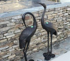 The 2 metal birds by hot tub.