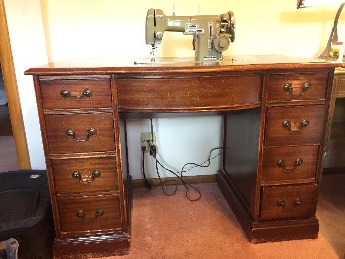 Necchi sewing machine hides in mahogany desk.  