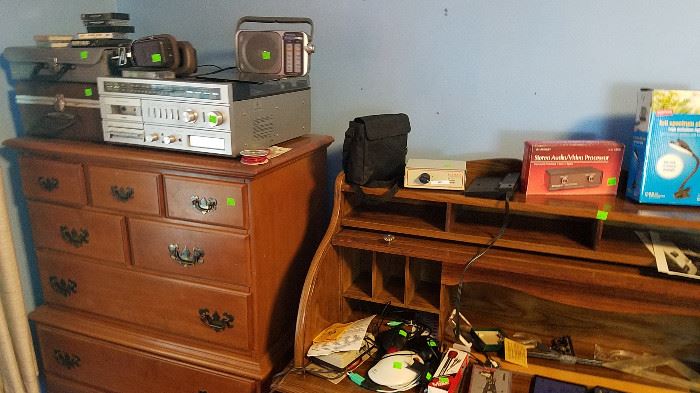 dresser, stereo receiver, tapes, electronics, roll top desk
