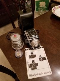 Hasselblad 500C Camera with base, an extra lense, and paperwork.