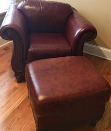 Leather arm chair with footrest
Embellished with grommets