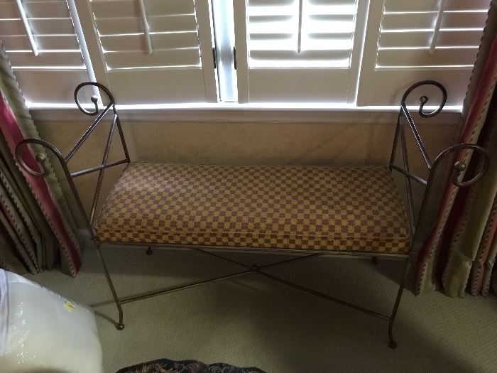 Wrought iron bench with upholstered cushion