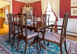 Beautifully restored antique dining table and newly upholstered chairs. 