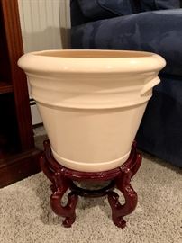 Large ceramic pot on wooden base