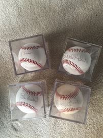 Baseball signed by Yogi Berra, Mickey Mantle, Stan Musial, and Brooks Robinson.