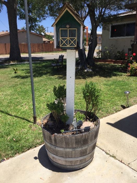 Old whiskey barrel with bird house, also yard bench, etc.