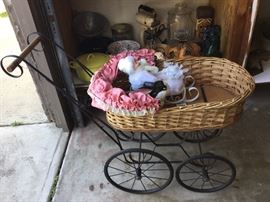 Wicker doll pram / buggyrolls nicely, iron work frame