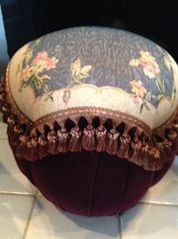 Upholstered foot stool with braid
