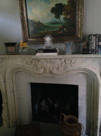 More framed art, books, and decorative items on another fireplace