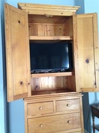 The pine armoire proves TV space and lots of storage