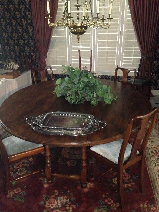 Exceptionally large round antique dining table; comfortable for 8 chairs (4 chairs showing)