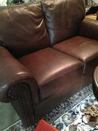 Brown leather loveseat