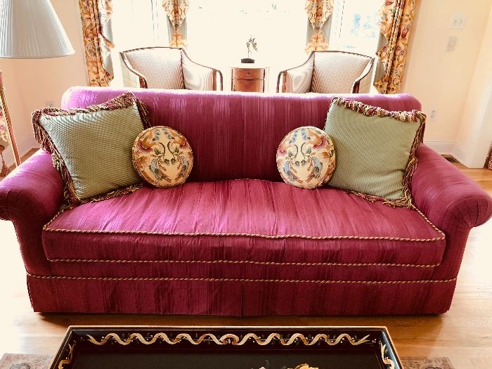 “Have to have it!” Beautiful, comfy, raspberry sofa with braided piping and accent pillows