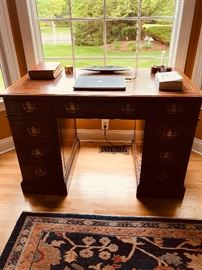 Antique distinguished desk with leather top and brass hardware