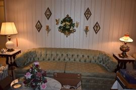 Beautifully Tufted Vintage Sofa, also Vintage Wall Hangings and Sconces surrounded by previously highlighted Victorian Marble Top Tables, Table Lamps and More!