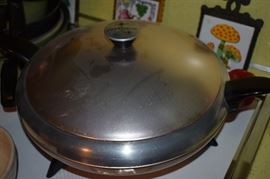 Cory Party Chef Space Age Atomic Server Buffet Fry Pan Electric Skillet. This Cory Party Chef Spaceship Mid Century Atomic Server Buffet Fry Pan is in good condition, tested and works perfectly. Temperature settings range from warm all the way up to 400°. An awesome server in a fantastic mid-century 1950's design! The outside body is polished silver tone aluminum (band) and copper-tone matte aluminum (top and bottom) and is SUPER CLEAN. The lids handle has a very minor dent. The interior cooking & warming area is silver-tone aluminum and in GREAT CONDITION. The black feet and arms/handles are heavy weight plastic with NO wear and NO damage. There are no instructions, but, the inside of the lid includes a basic guide to temperatures. The plug/cord is super clean little to no signs of wear. This COOL FRY PAN measures 18 1/2" handle to handle, 12" across the interior cooking area and about 8" high when the lid is on.