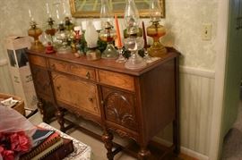 Beautiful Circa 1920's Dining Room Suite featuring Dining Table, 6 Matching Chairs, China Closet, and Buffet featuring Tudor Legs and Carvings