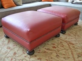 Pair of red leather ottomans
