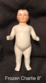 Antique German China White Tinted 8" Frozen Charlie Doll.  Frozen Charlie dolls were made in German by various firms between the 1850s to the early 1900s. This Charlie stands 8" tall and his body is white tinted with dark hair.