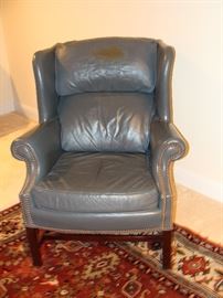 Pair of leather upholstered wing back chairs.