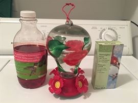 Humming bird feeder with nectar