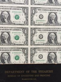 Sheet of uncut one dollar bills.