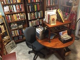 Library overflowing with books. Handcrafted David Clifton  mesquite dining table that lowers to become a coffee table. Maple coffee table from Denmark.