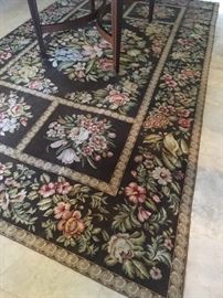 Needle point beautiful rug with a small rip