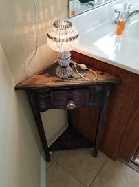 A very cool smaller corner stand for a bathroom vanity!