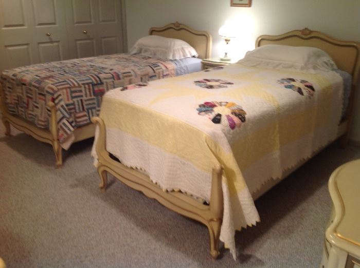 Drexel twin beds with quilts.