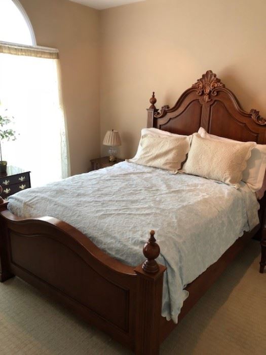 Several ornate, wooden bedroom suites are available.