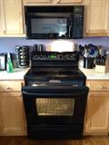 Black GR profile electric stove and microwave featuring two cooking racks