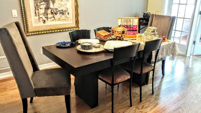 Modern dining table with two tall-back captains chairs