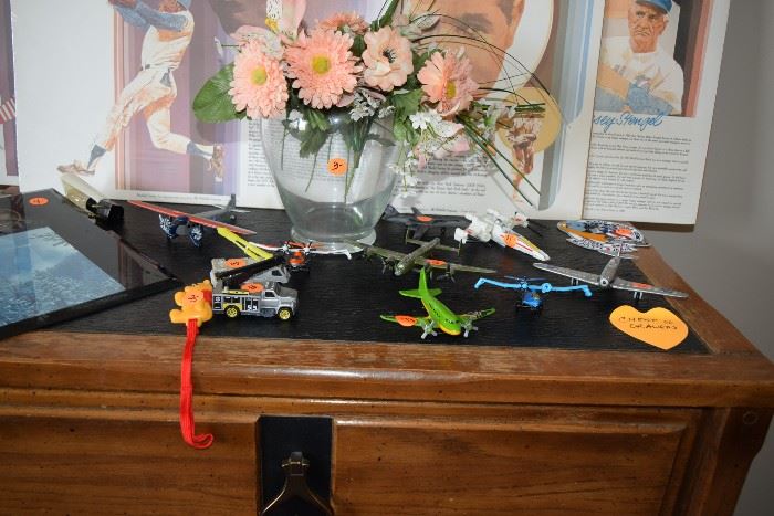 Sports memorabilia, toy planes, floral piece