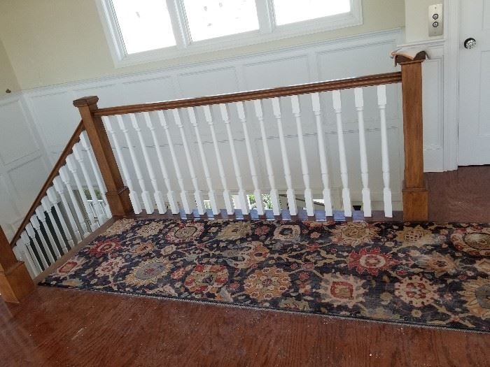 Handsome stairway; nice rugs