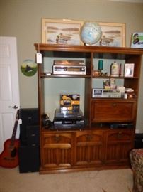 Electronics, turntable, speakers, guitar, world globe, all on solid wood entertainment center