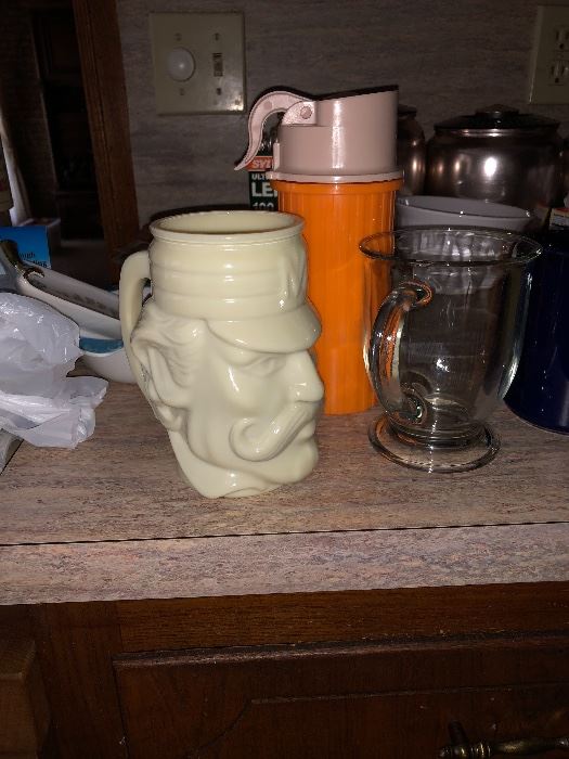 Avon baseball head coffee mug, glass coffee mug, and a no spill cup.