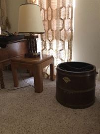 A barrel style magazine holder, a nice older lamp, and small table.