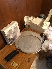 Meat slicer, splatter screens for cooking, little ramekins, and an Avon glass candle holder.