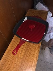 Enameled cast iron pan with bacon, steak press.