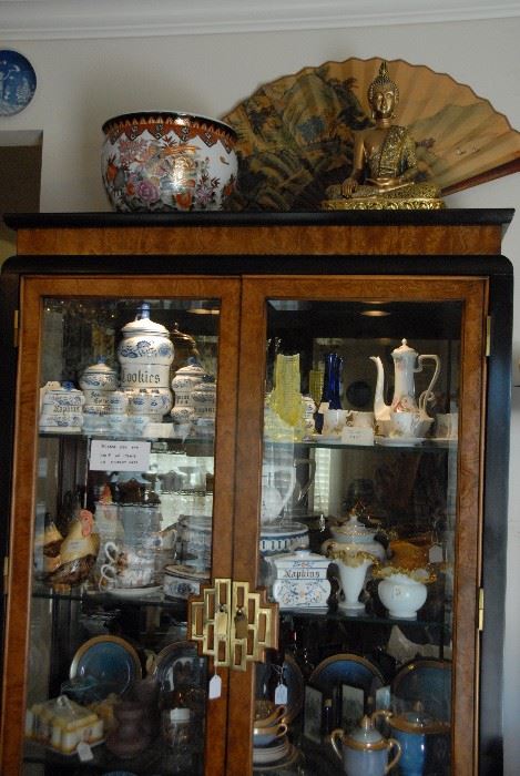 Great Asian Design China cabinet full of vintage and beautiful china and glassware.