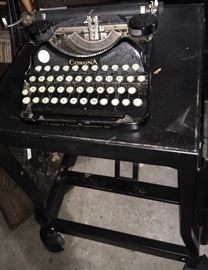 Vintage Corona typewriter and industrial metal table on wheels (sold separately)